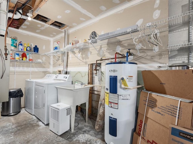 washroom featuring washer and dryer, water heater, and a sink
