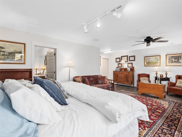 bedroom with ceiling fan and dark wood finished floors