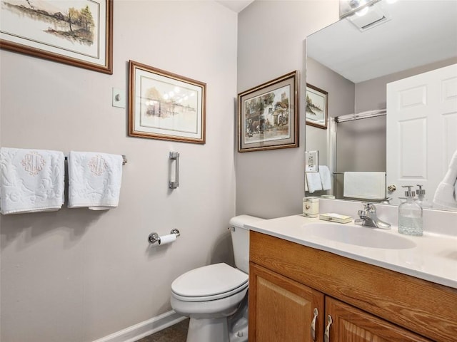 bathroom with a shower with door, visible vents, toilet, vanity, and baseboards