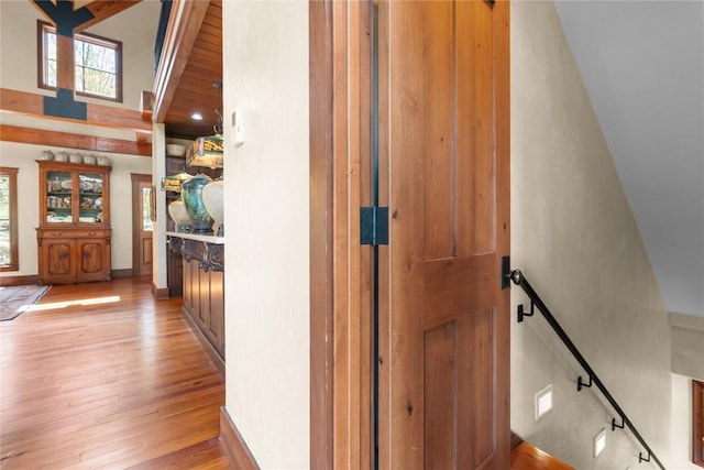stairs featuring wood finished floors and a towering ceiling