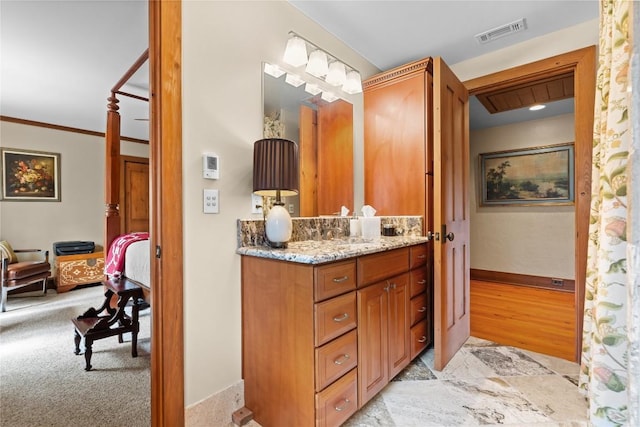 bathroom with ensuite bathroom, baseboards, and vanity