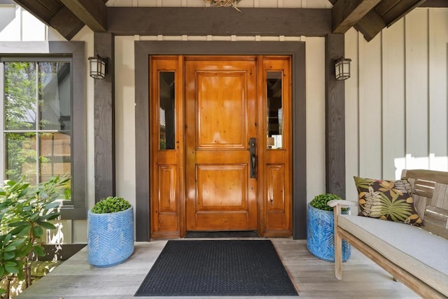 doorway to property featuring board and batten siding