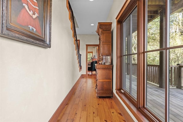 hallway featuring light wood-style flooring and recessed lighting