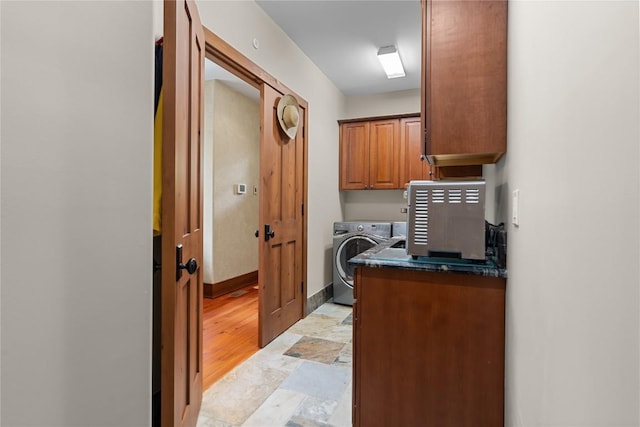 office area featuring washer / clothes dryer, light stone finish flooring, and baseboards