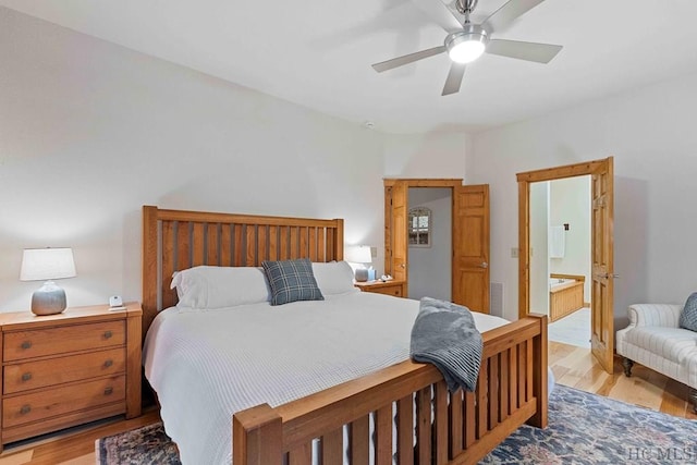 bedroom featuring connected bathroom, ceiling fan, and light hardwood / wood-style flooring