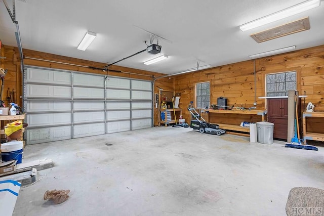 garage with a garage door opener and wood walls