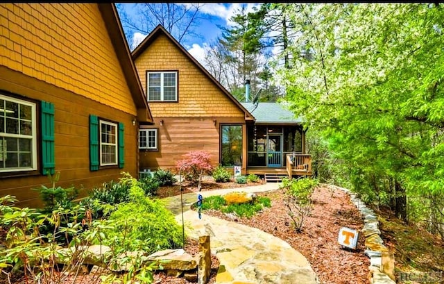 rear view of house with a patio area and a sunroom