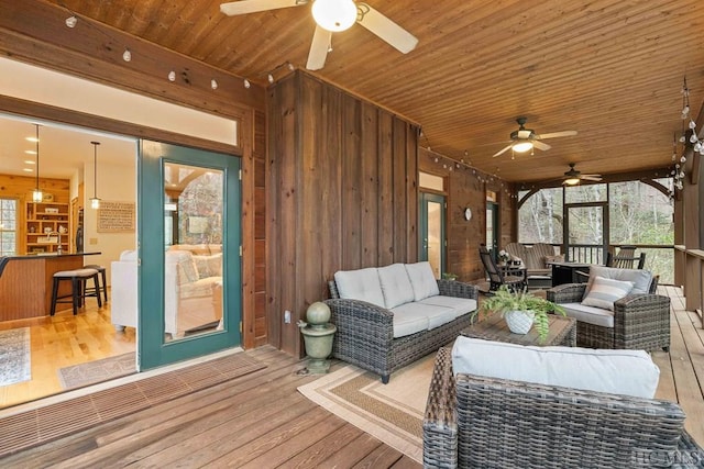 wooden terrace featuring ceiling fan and outdoor lounge area