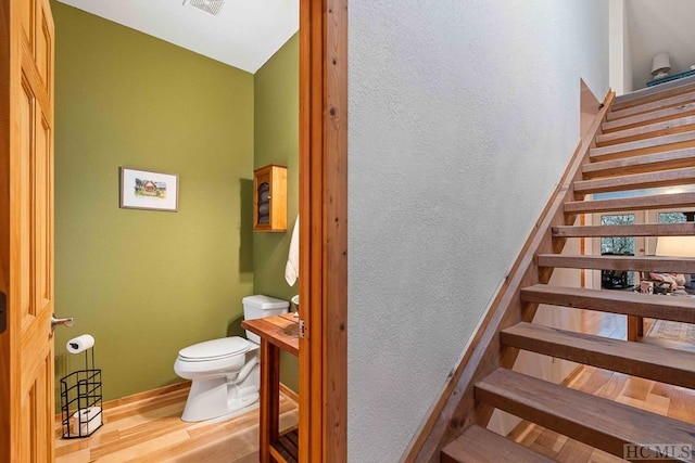 staircase with hardwood / wood-style floors