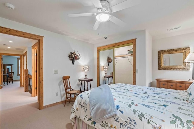 carpeted bedroom featuring ceiling fan and a closet