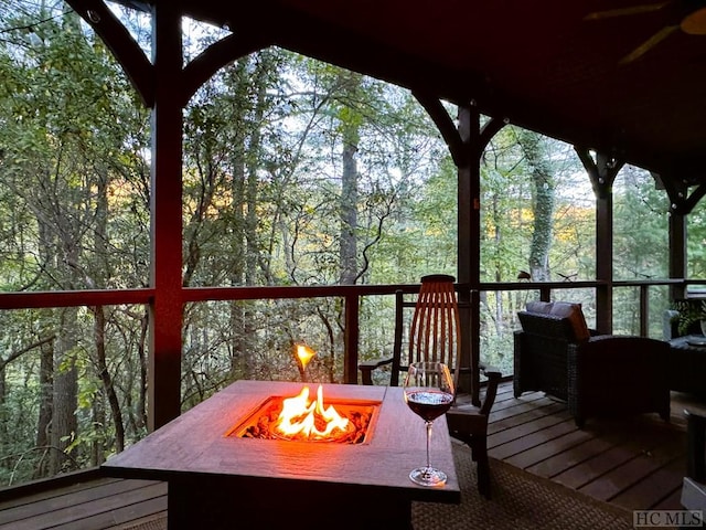 wooden deck featuring an outdoor fire pit