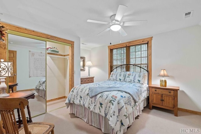 carpeted bedroom with a closet and ceiling fan