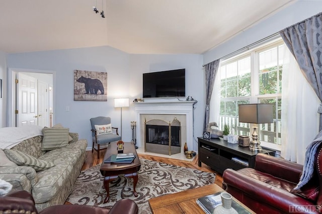 living room featuring hardwood / wood-style floors and vaulted ceiling