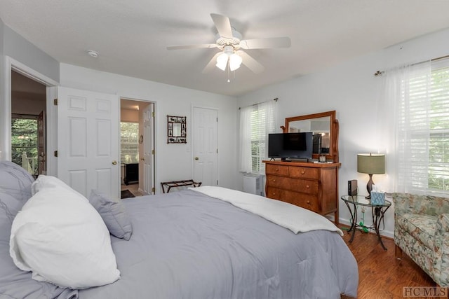 bedroom featuring hardwood / wood-style flooring, ensuite bathroom, and ceiling fan