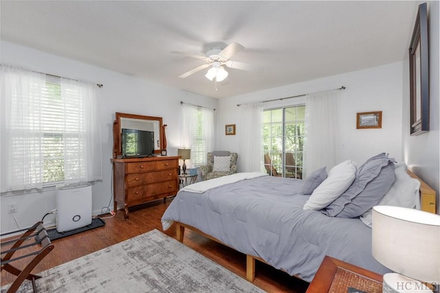 bedroom featuring ceiling fan, access to exterior, and hardwood / wood-style floors