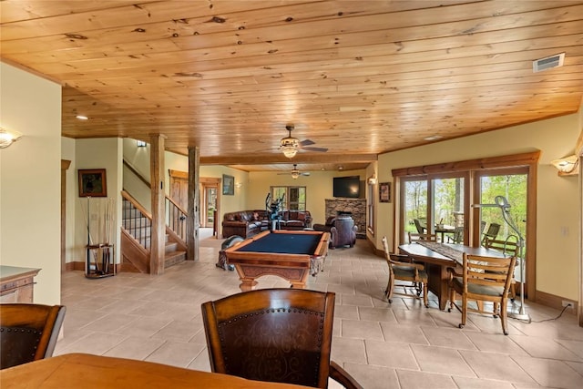 rec room with billiards, a stone fireplace, healthy amount of natural light, a ceiling fan, and wooden ceiling