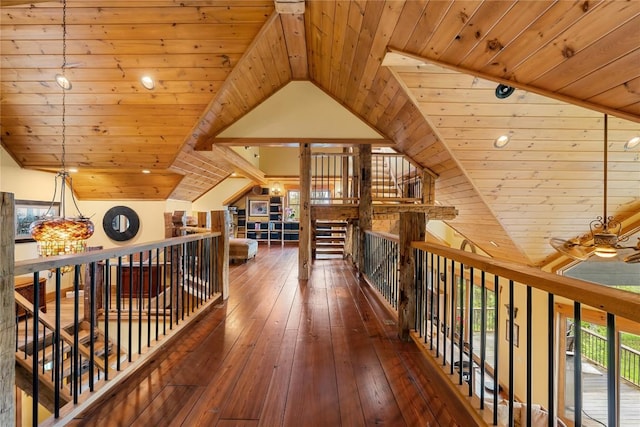 corridor featuring wooden ceiling, lofted ceiling, hardwood / wood-style flooring, and an upstairs landing