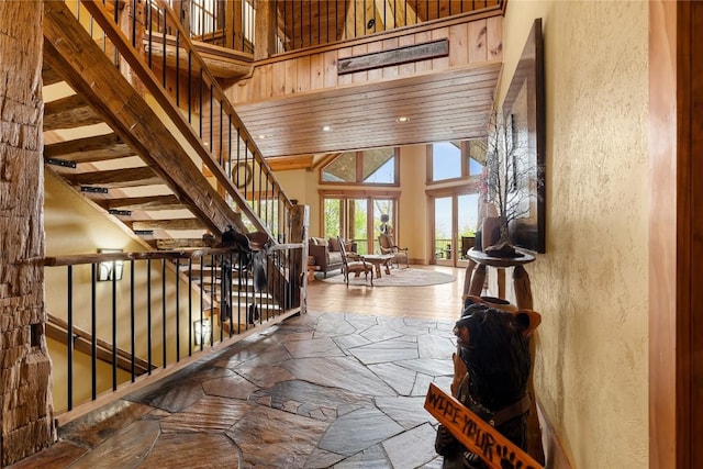 stairway with a towering ceiling and a textured wall