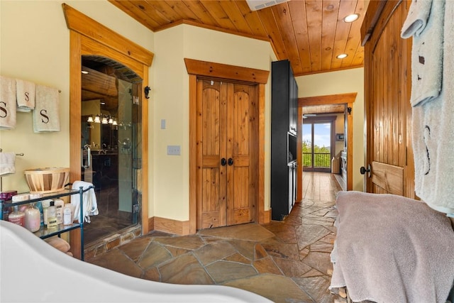 bedroom with wood ceiling, stone finish flooring, recessed lighting, a closet, and crown molding