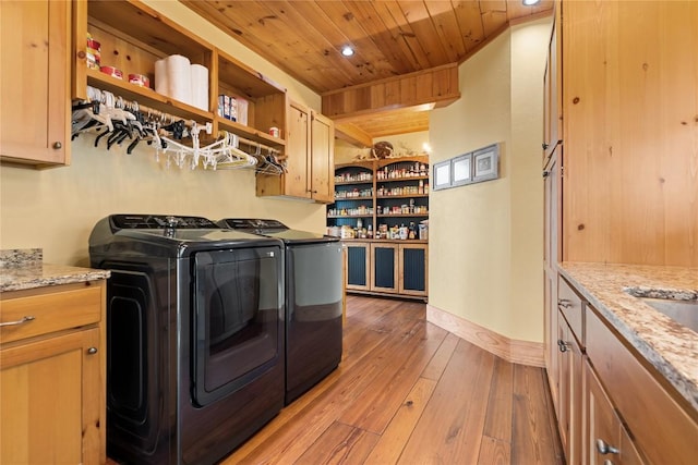 clothes washing area featuring cabinet space, washing machine and dryer, wooden ceiling, light wood-type flooring, and recessed lighting