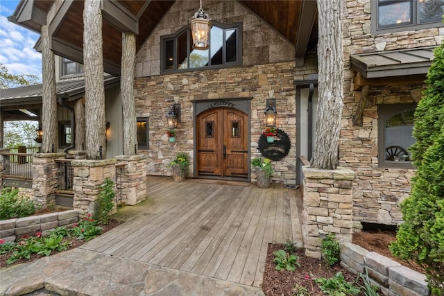 entrance to property with stone siding and covered porch