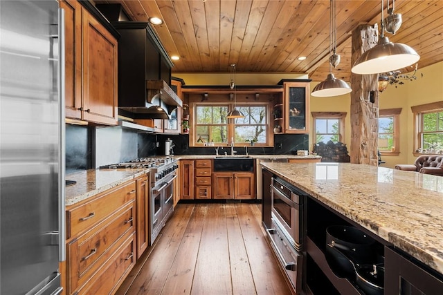kitchen featuring high end appliances, wood ceiling, recessed lighting, light stone counters, and light wood-style flooring