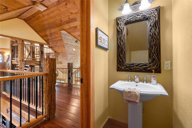bathroom with wood ceiling, hardwood / wood-style flooring, a chandelier, and vaulted ceiling