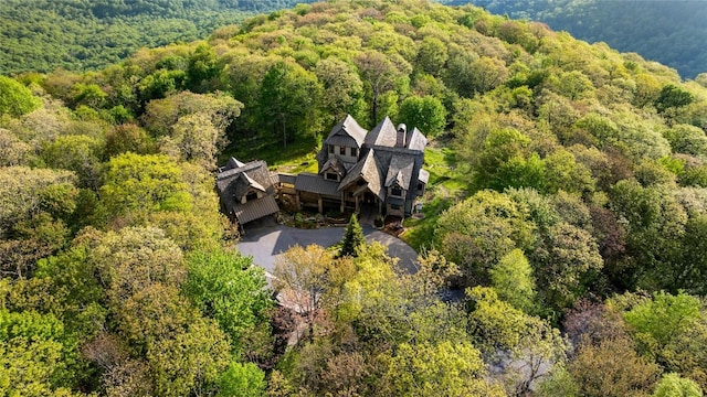 view of subject property featuring a heavily wooded area