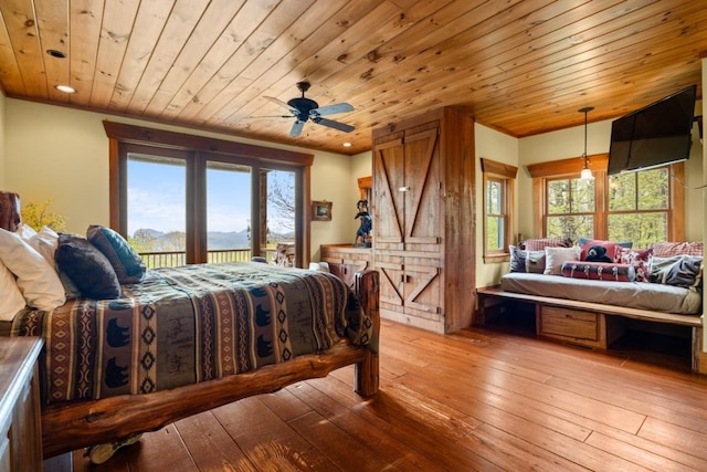 bedroom with access to outside, light wood finished floors, multiple windows, wood ceiling, and recessed lighting