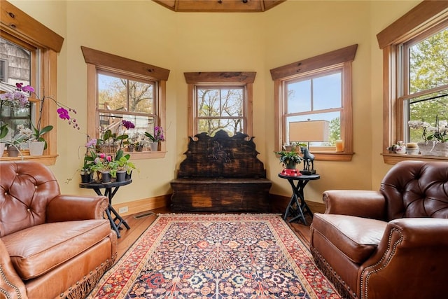 sitting room with wood finished floors and baseboards