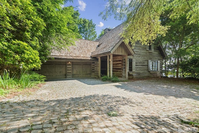 log cabin featuring a garage