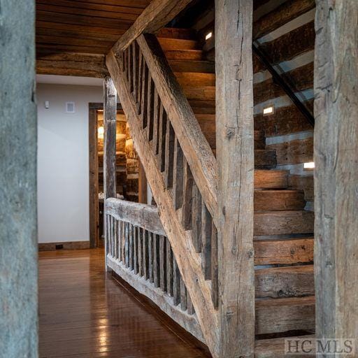 stairway featuring wood-type flooring and wood ceiling