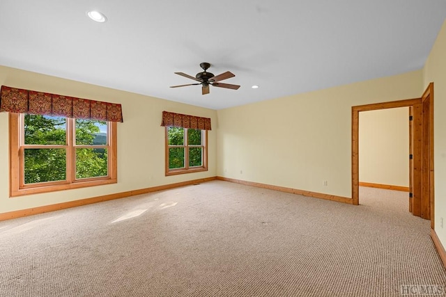 carpeted empty room featuring ceiling fan