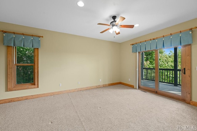 unfurnished room featuring ceiling fan and carpet floors