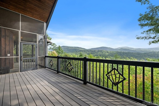 deck with a mountain view and a sunroom