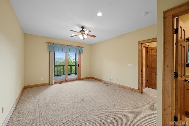 spare room featuring ceiling fan and light colored carpet