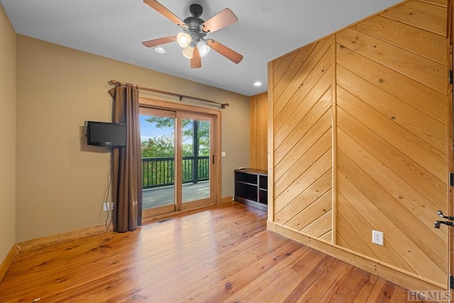 empty room with ceiling fan and light wood-type flooring