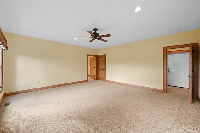 carpeted empty room featuring ceiling fan