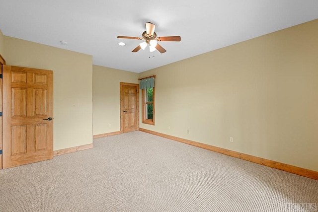 carpeted empty room featuring ceiling fan