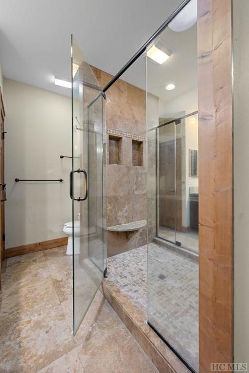 bathroom featuring toilet and walk in shower