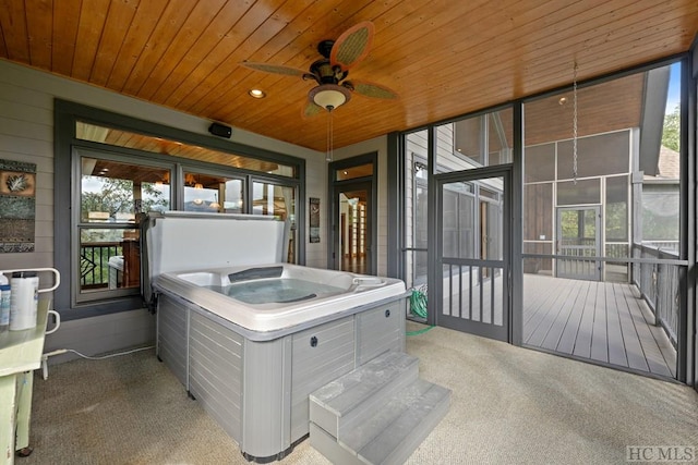 sunroom / solarium with wood ceiling, a wealth of natural light, and a hot tub