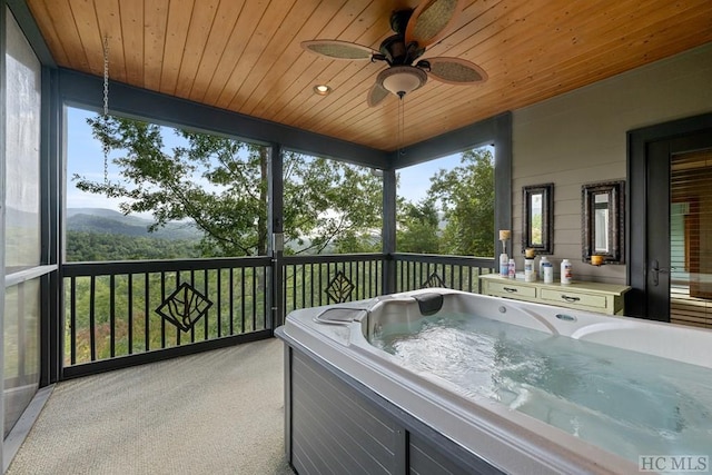 sunroom with wood ceiling and a jacuzzi