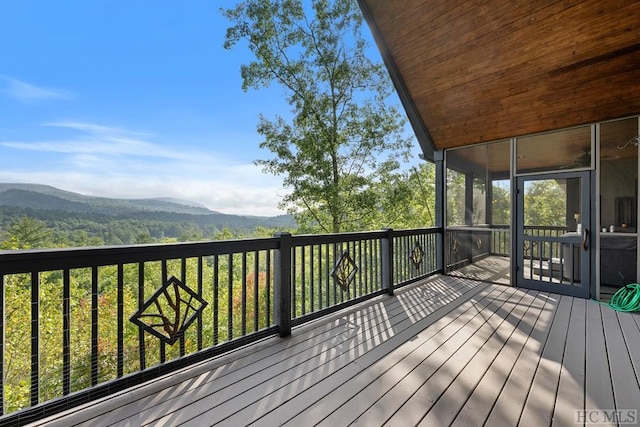 wooden terrace with a mountain view and a sunroom