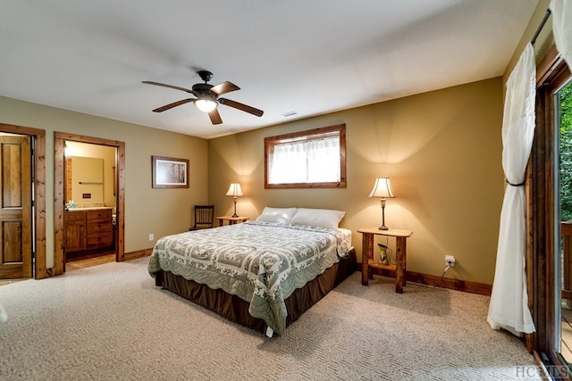 bedroom featuring carpet floors, ceiling fan, and ensuite bath