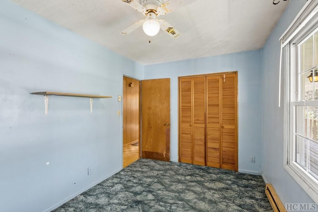 unfurnished bedroom with a closet, dark colored carpet, and ceiling fan