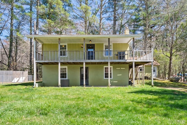 back of property featuring a yard and a deck