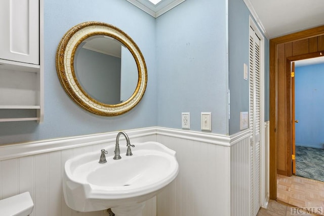 bathroom with parquet flooring and sink