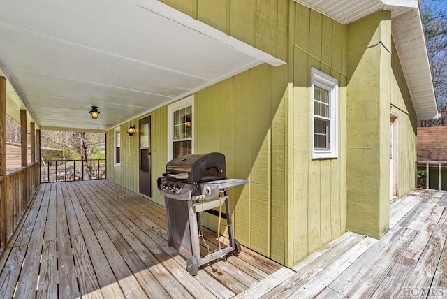 wooden terrace featuring a grill