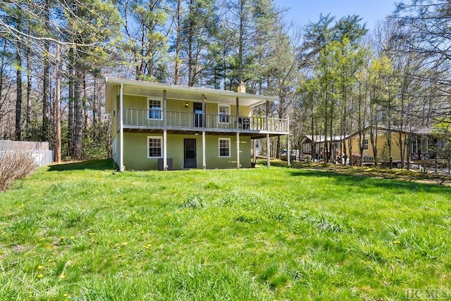 rear view of house featuring a lawn