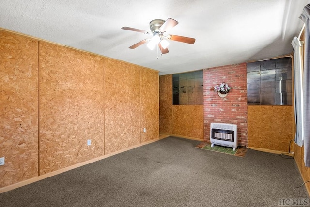 interior space featuring heating unit and ceiling fan